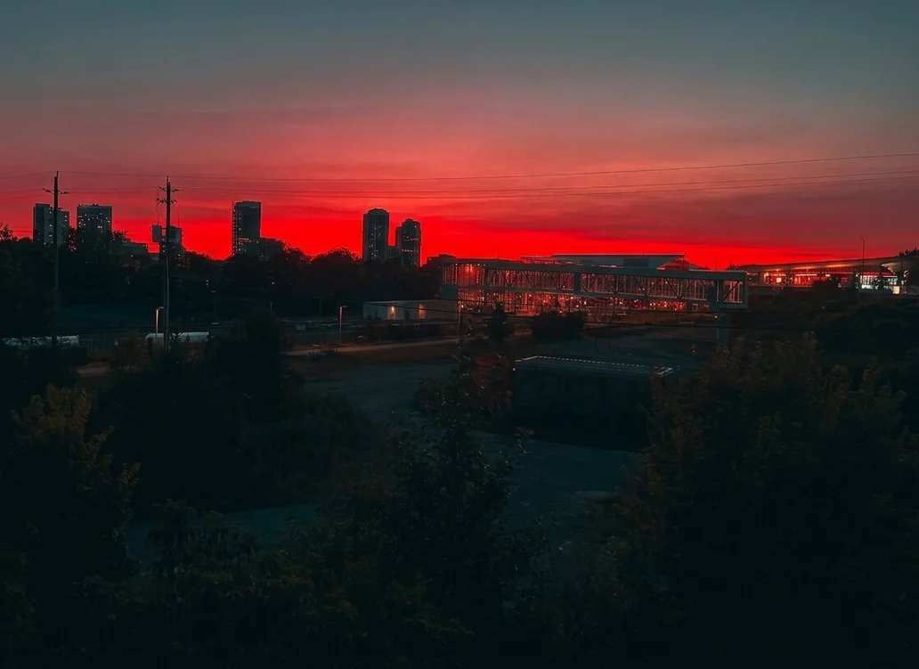 City skyline at sunset with vivid red sky