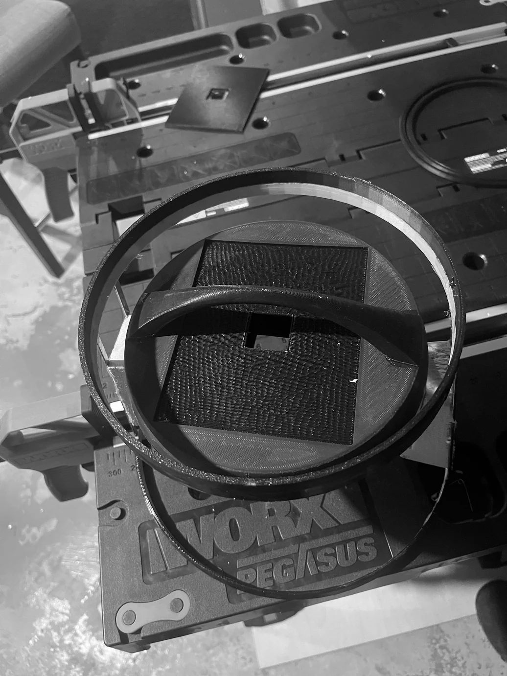 Large acrylic ring being cut or formed — structural ring for the lamp body