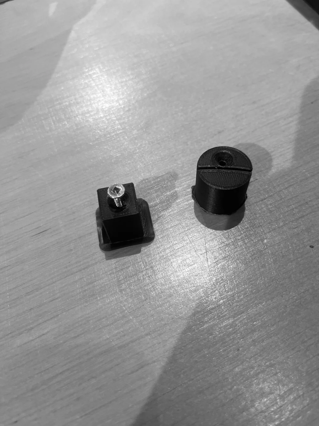 Two small black 3D-printed connector pieces