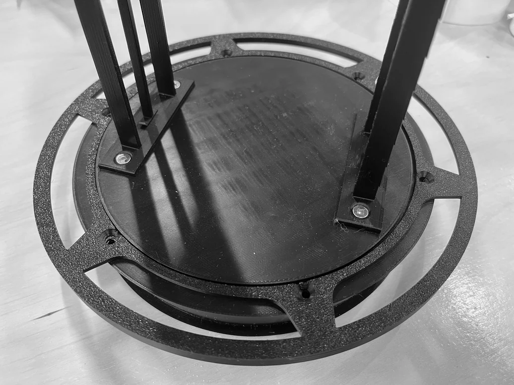 Close-up of the 3D-printed base disc with extrusion rods