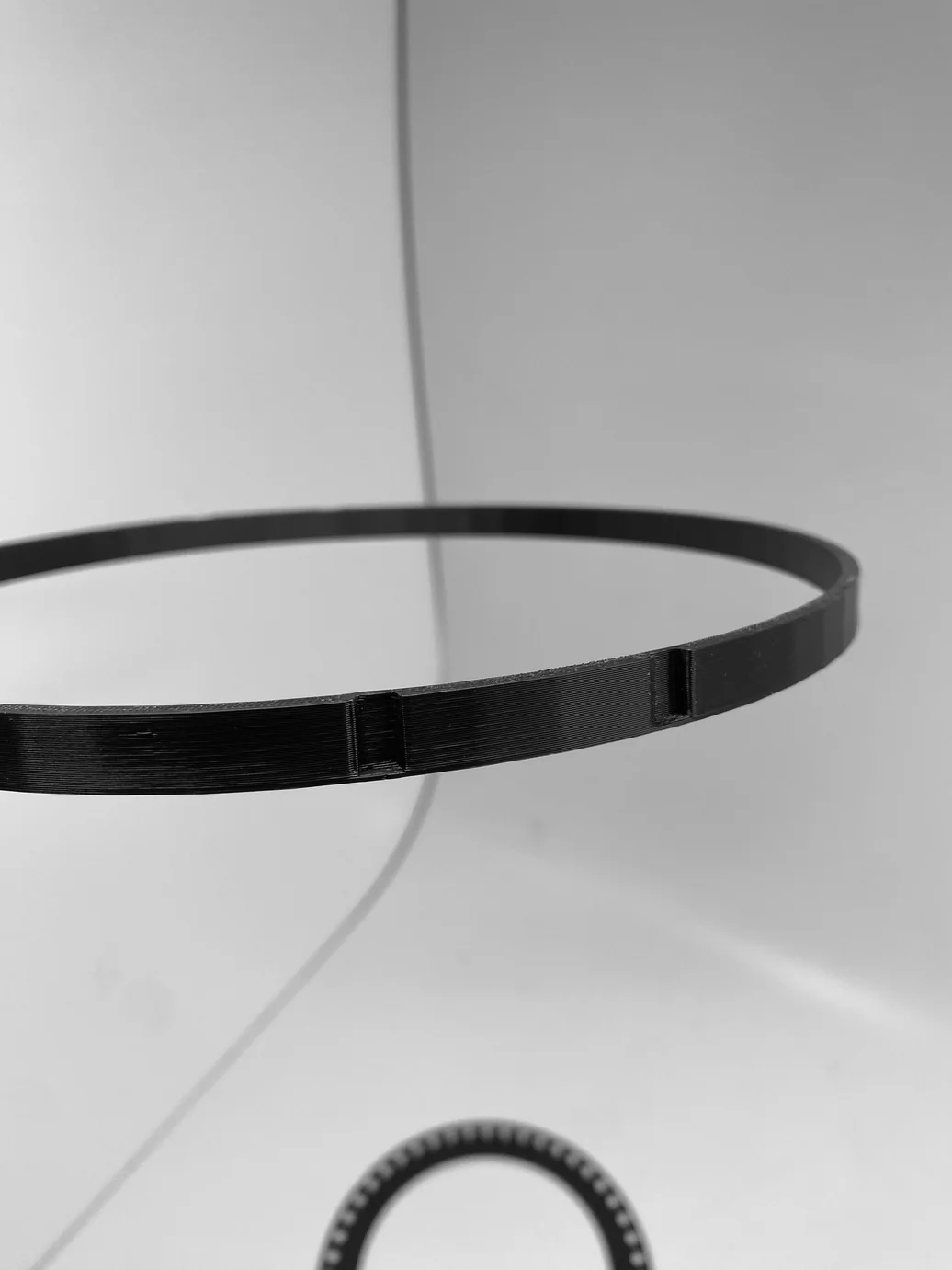 Thin black 3D-printed ring close-up