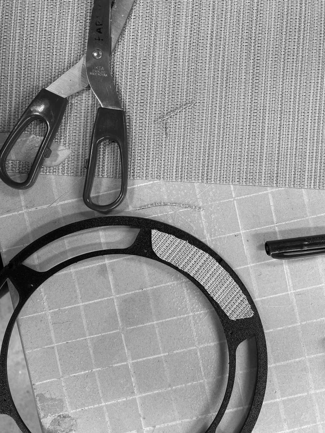 Scissors and ring frame laid on fabric during cutting