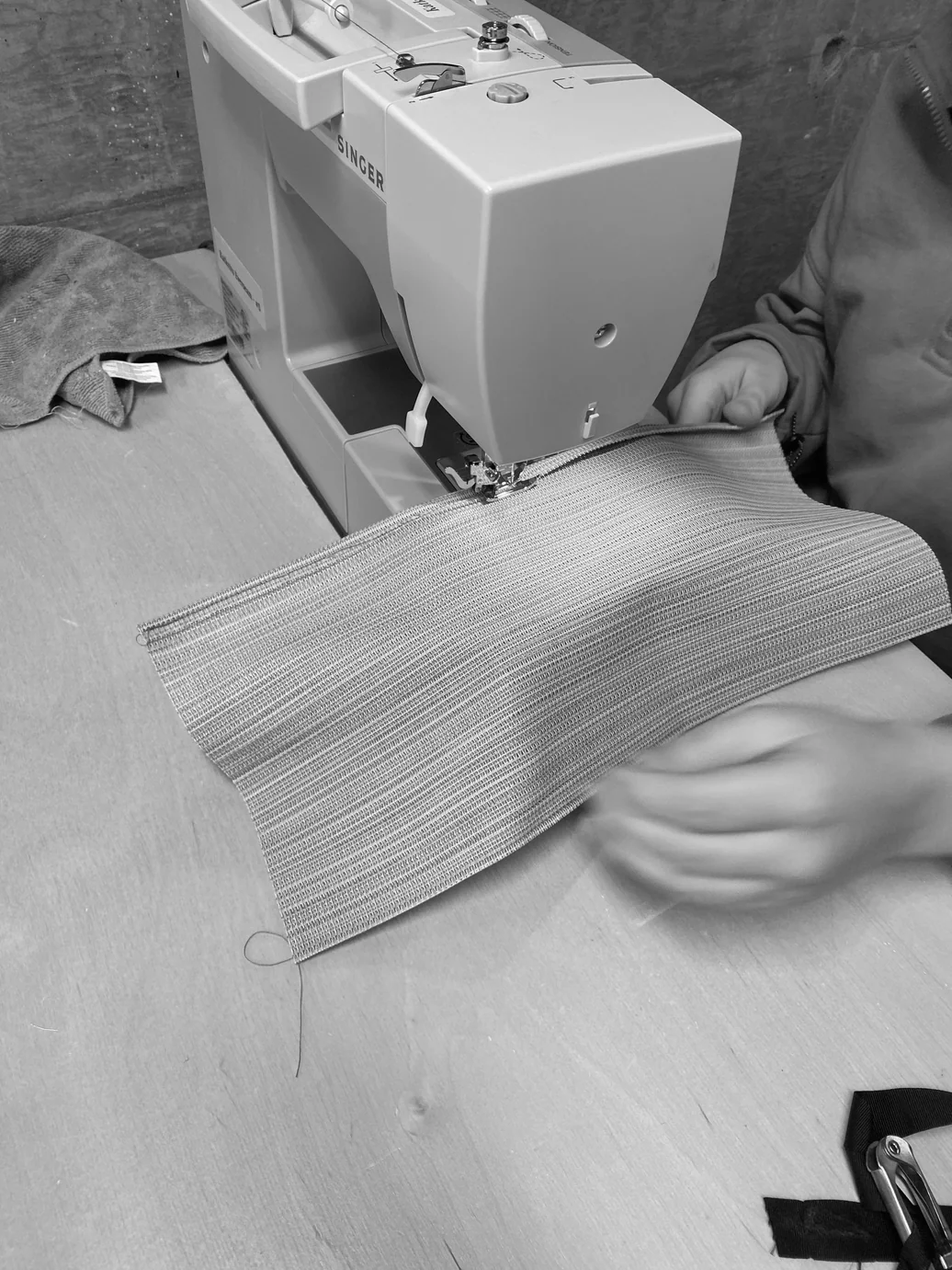 Sewing the woven fabric shade at a sewing machine