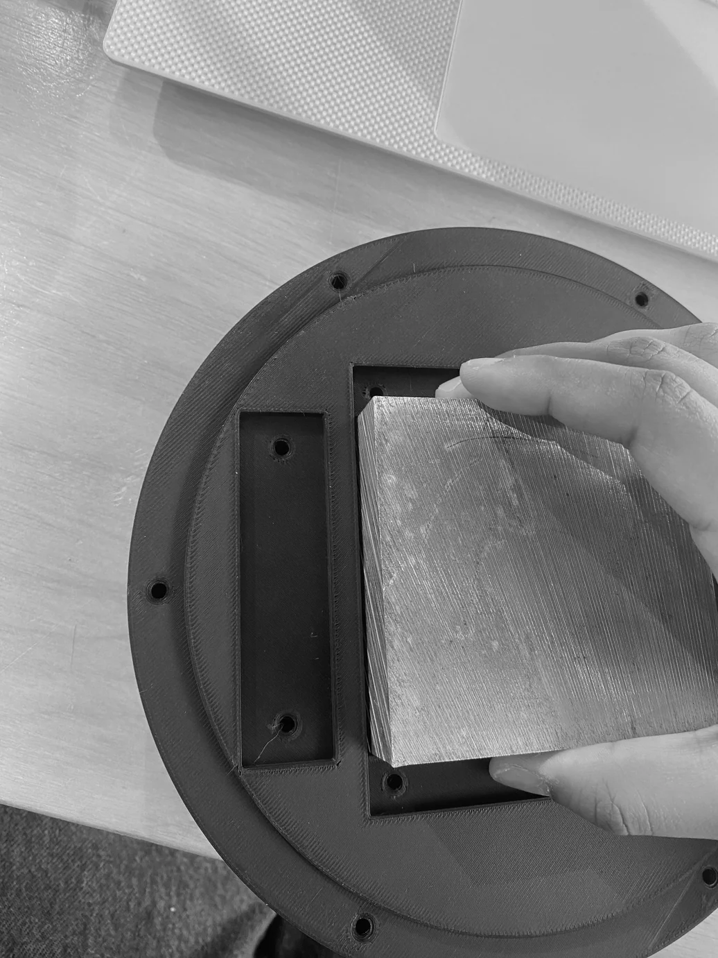 Hand inserting a spring steel strip into the 3D-printed base