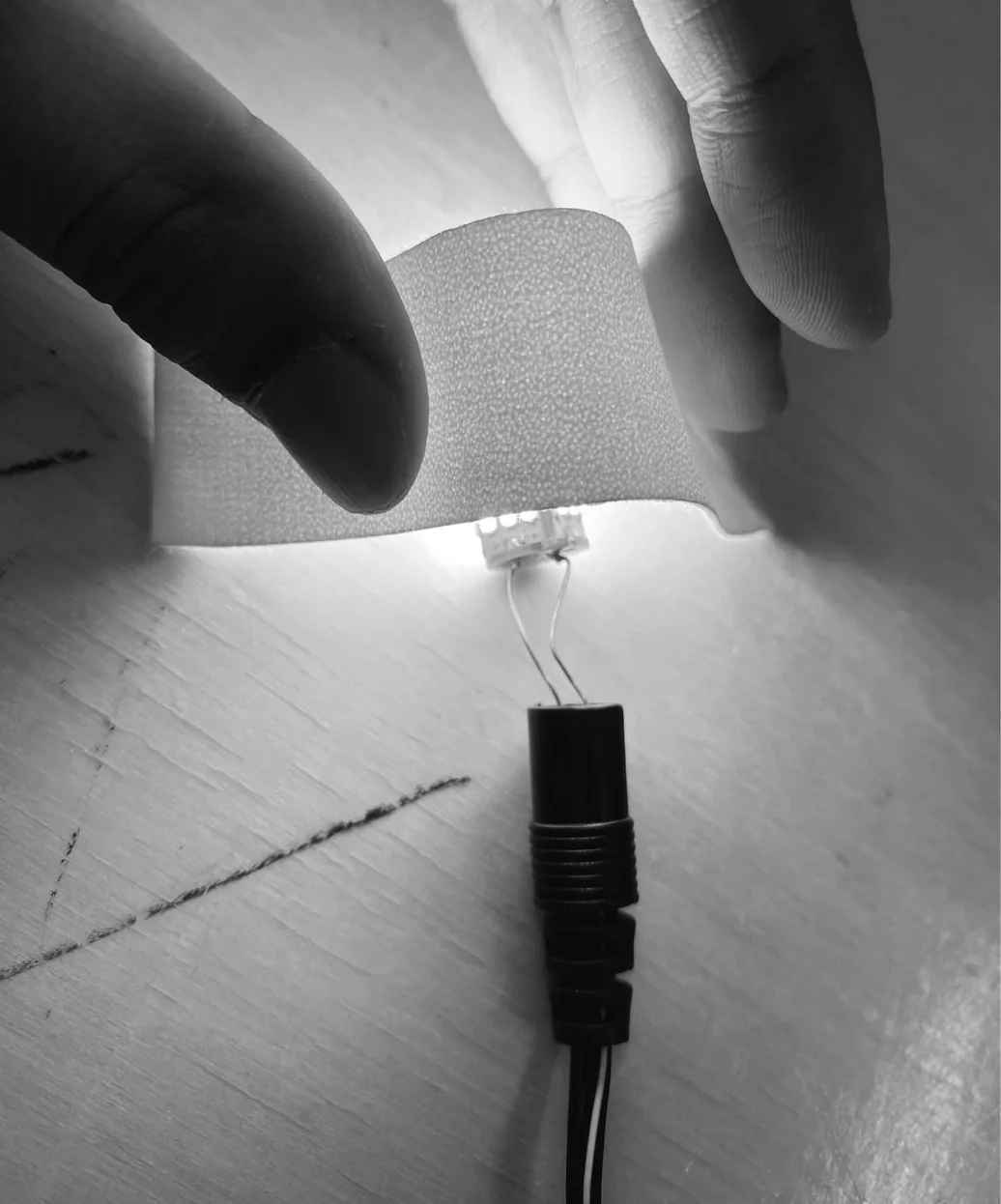 Woven outdoor fabric glowing softly over an LED — confirming the diffusion quality