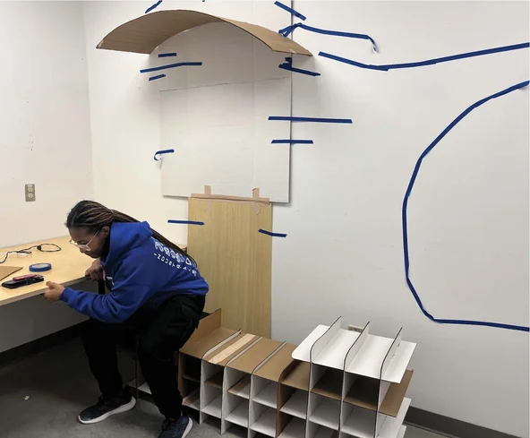 Designer testing seating posture at the full-scale mockup